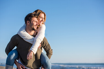 Image showing couple having fun at beach during autumn