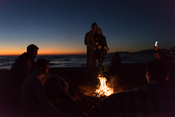 Image showing Friends having fun at beach on autumn day