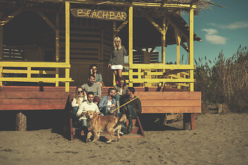 Image showing Group of friends having fun on autumn day at beach