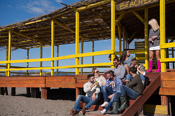 Image showing Group of friends having fun on autumn day at beach