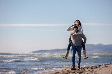 Image showing couple having fun at beach during autumn