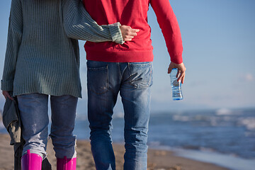 Image showing Loving young couple on a beach at autumn sunny day