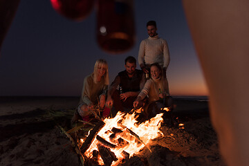 Image showing Friends having fun at beach on autumn day