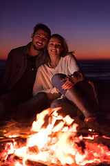 Image showing portrait of young Couple enjoying  at night on the beach