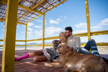 Image showing Couple with dog enjoying time on beach