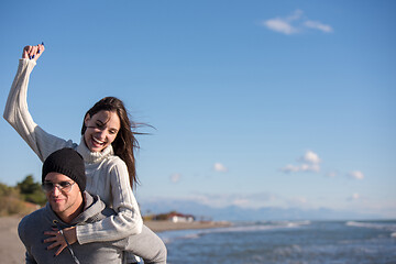 Image showing couple having fun at beach during autumn