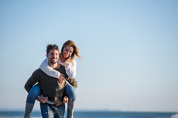 Image showing couple having fun at beach during autumn