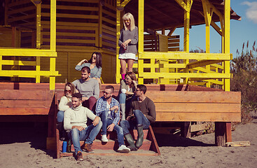 Image showing Group of friends having fun on autumn day at beach