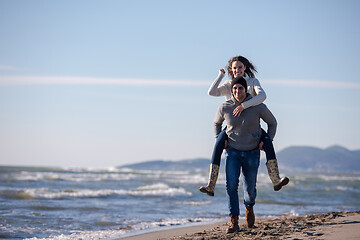 Image showing couple having fun at beach during autumn