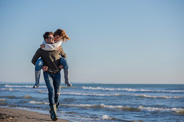 Image showing couple having fun at beach during autumn