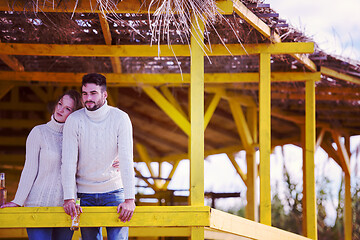 Image showing young couple drinking beer together at the beach