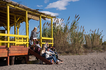 Image showing Group of friends having fun on autumn day at beach