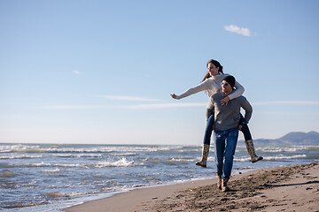 Image showing couple having fun at beach during autumn