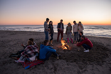 Image showing Friends having fun at beach on autumn day