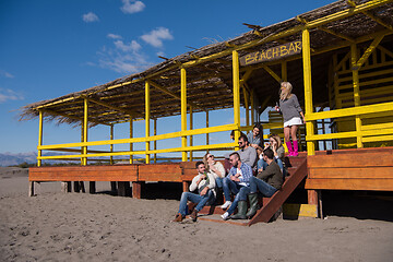 Image showing Group of friends having fun on autumn day at beach