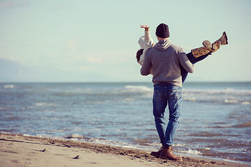 Image showing Loving young couple on a beach at autumn sunny day