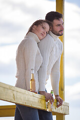 Image showing young couple drinking beer together at the beach