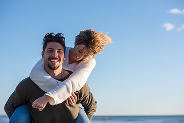 Image showing couple having fun at beach during autumn