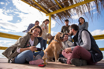 Image showing Group of friends having fun on autumn day at beach