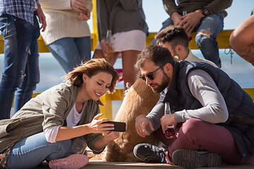 Image showing Group of friends having fun on autumn day at beach