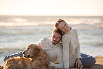 Image showing Couple with dog enjoying time on beach