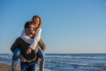 Image showing couple having fun at beach during autumn