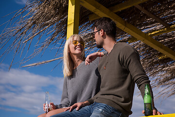 Image showing young couple drinking beer together at the beach