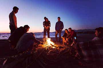 Image showing Friends having fun at beach on autumn day