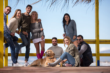 Image showing Group of friends having fun on autumn day at beach