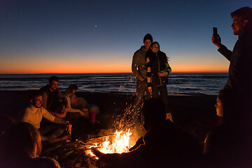 Image showing Friends having fun at beach on autumn day