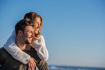 Image showing couple having fun at beach during autumn