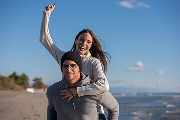 Image showing couple having fun at beach during autumn