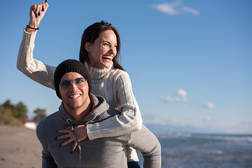 Image showing couple having fun at beach during autumn