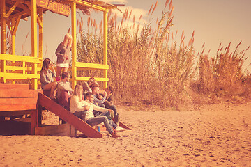 Image showing Group of friends having fun on autumn day at beach