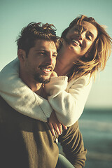 Image showing couple having fun at beach during autumn