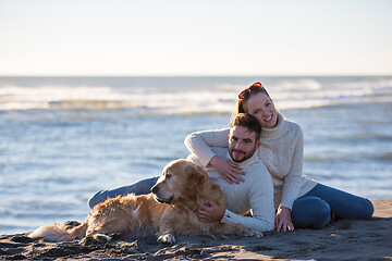 Image showing Couple with dog enjoying time on beach