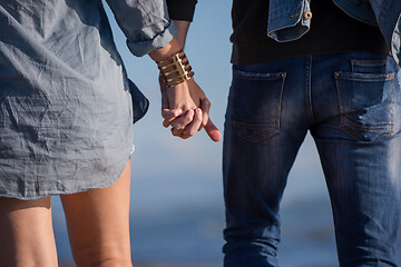 Image showing Loving young couple on a beach at autumn sunny day