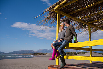 Image showing young couple drinking beer together at the beach