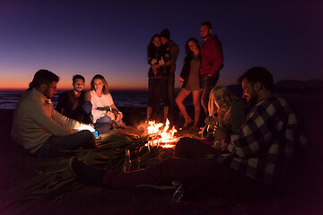 Image showing Friends having fun at beach on autumn day