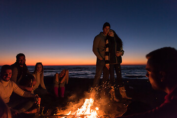 Image showing Friends having fun at beach on autumn day