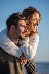 Image showing couple having fun at beach during autumn