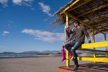 Image showing young couple drinking beer together at the beach