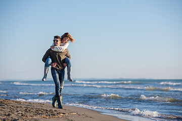 Image showing couple having fun at beach during autumn