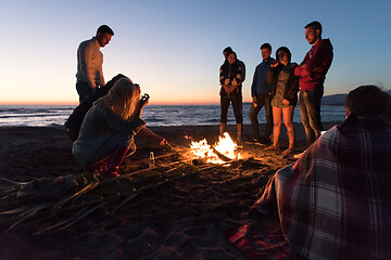 Image showing Friends having fun at beach on autumn day