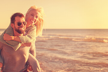 Image showing couple having fun at beach during autumn