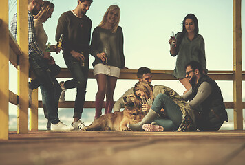 Image showing Group of friends having fun on autumn day at beach