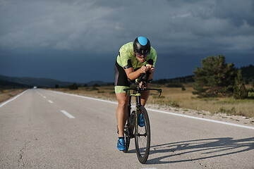 Image showing triathlon athlete riding bike