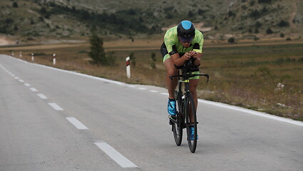 Image showing triathlon athlete riding bike