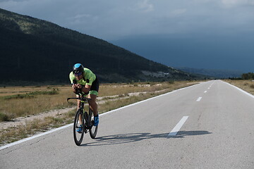 Image showing triathlon athlete riding bike