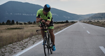 Image showing triathlon athlete riding bike